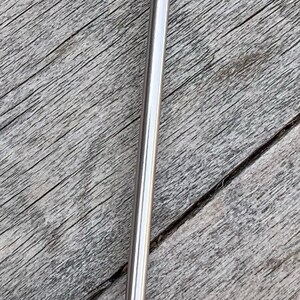 May include: A silver stirring stick with a round, flat top that says "coffee is my boyfriend".