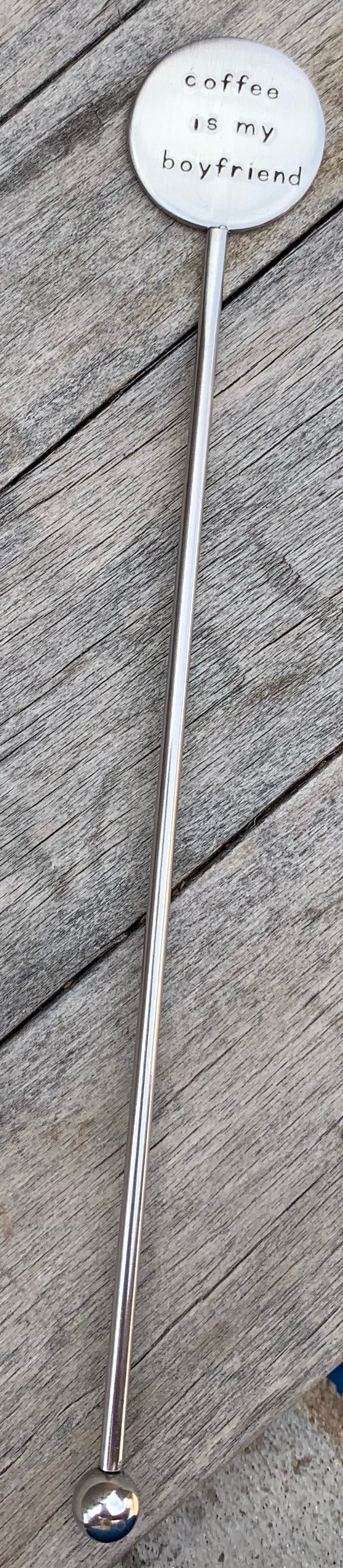 May include: A silver stirring stick with a round, flat top that says "coffee is my boyfriend".