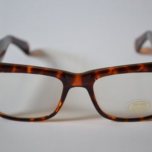 May include: Tortoise shell eyeglasses with clear lenses and a UV400 label on the right lens.