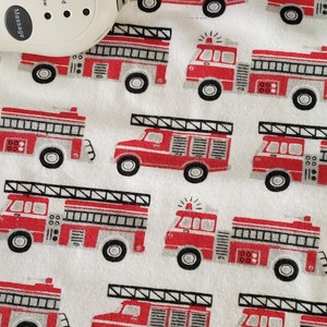 May include: White electric heated blanket with a red fire truck pattern. The control has buttons for Hi, Med, Low, Heat, and Massage.