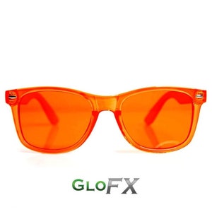 May include: Orange tinted sunglasses with a black frame. The sunglasses are made of plastic and have a classic aviator style.