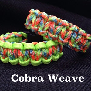 May include: Two colorful paracord bracelets in a cobra weave pattern. The bracelets are made with green, orange, blue, and red paracord.