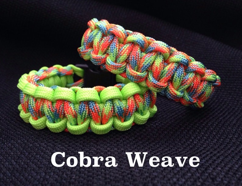 May include: Two colorful paracord bracelets in a cobra weave pattern. The bracelets are made with green, orange, blue, and red paracord.