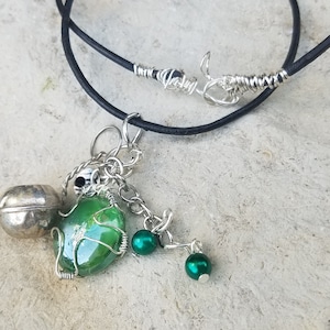 Four Green and Silver Dangle Charms on a Black Cord Necklace