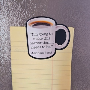 May include: A black and white coffee mug magnet with a quote from the TV show "The Office" that reads: "I'm going to make this harder than it needs to be." - Michael Scott