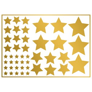 May include: A collection of gold-colored star stickers in various sizes, arranged on a white background within a gold rectangular border. The stars range from small to large, creating a decorative design.