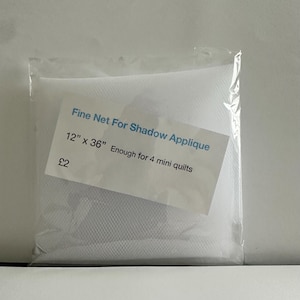 May include: White fine mesh netting for shadow applique, 12 inches by 36 inches, enough for 4 mini quilts.  The netting is packaged in a clear plastic bag with a white label that reads "Fine Net For Shadow Applique 12" x 36" Enough for 4 mini quilts £2".