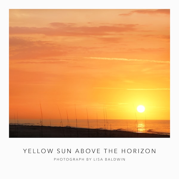 Deep Golden Sunrise Photo with Sun Just Above the Horizon Reflected in the Ocean Water - Sunrise at the Beach