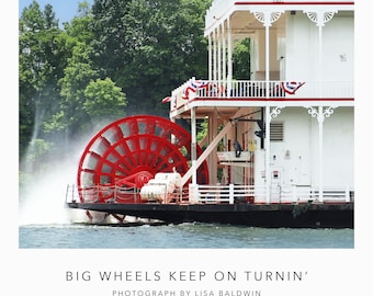 Photo of a Vintage Southern Riverboat with a Bright Red Paddlewheel Steaming down the Tennessee River Near Savannah