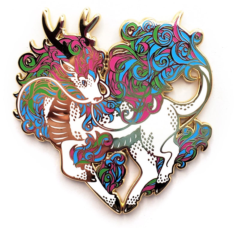 May include: Gold-tone enamel pin featuring a stylized white creature with blue, green, and pink swirling patterns. The creature has a long, flowing mane and a single horn.