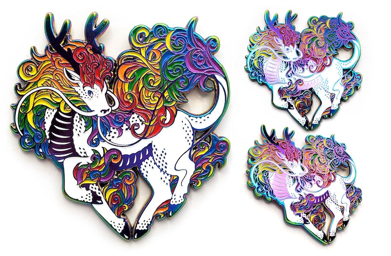 May include: Rainbow enamel pin featuring a mythical creature with a dragon head and a unicorn body. The creature is surrounded by swirling rainbow-colored designs.
