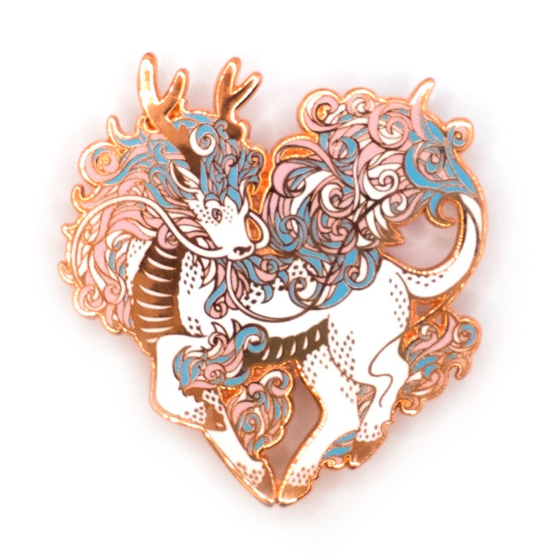 May include: A white enamel pin with a detailed design of a mythical creature with a dragon-like head and a unicorn-like body. The creature is surrounded by pink and blue swirls and has gold accents.