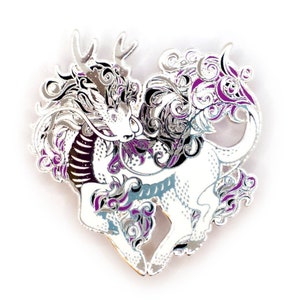 May include: Silver enamel pin featuring a stylized dragon with purple and black accents. The dragon is in a heart shape and has a detailed design.