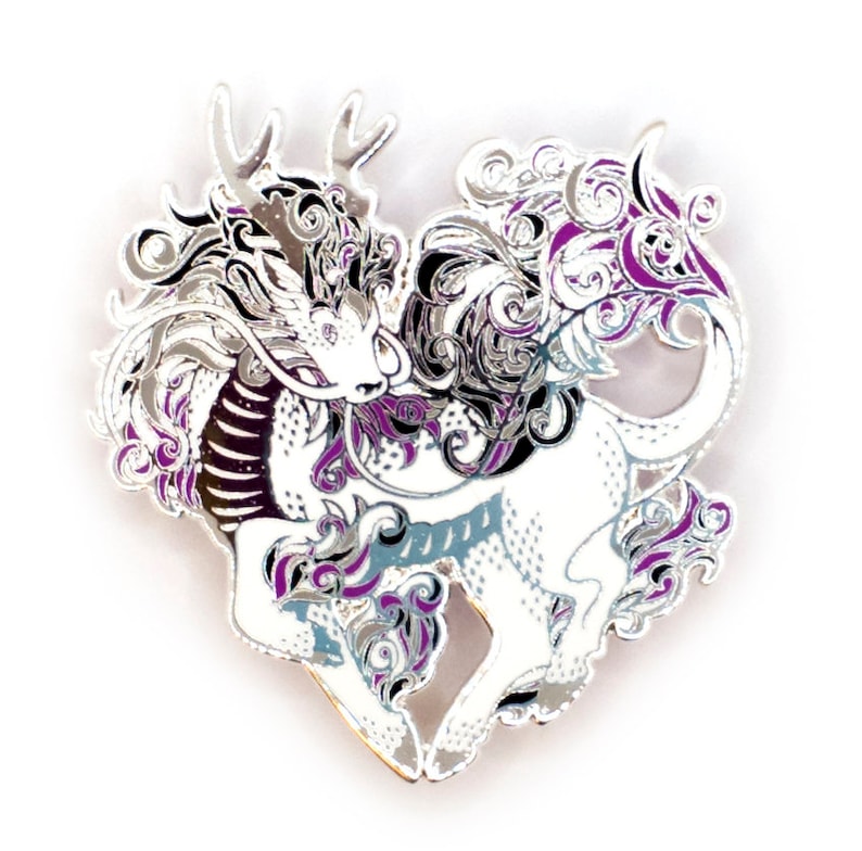 May include: Silver enamel pin featuring a stylized dragon with purple and black accents. The dragon is in a heart shape and has a detailed design.