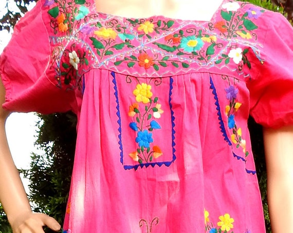 Pink dress with hand embroidery, floor length, from Mexico.