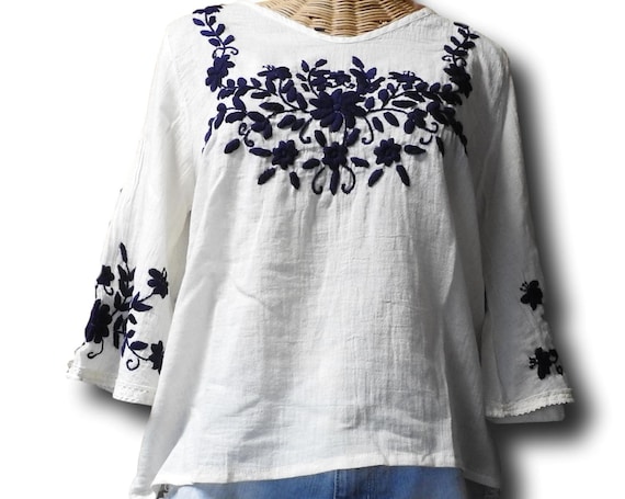 White top with blue embroidery