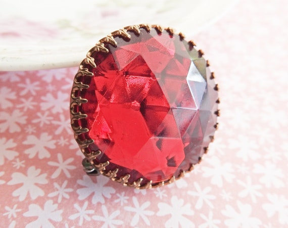 Red round brooch
