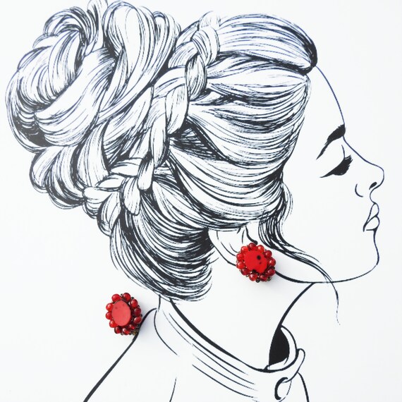 Red clip on earrings.