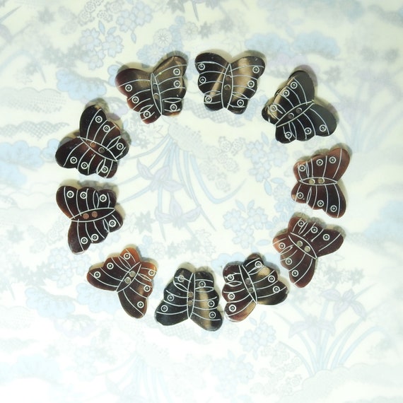 Carved sea shell sewing buttons, lot of 10, butterfly-shaped and vintage-inspired, for making boho wrist cuff bracelet or hipster jewelry.