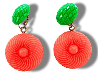 Bold and funky 1980s-inspired large neon dangle clip earrings in green and orange. Lightweight, Retro party-perfect and gift-ready