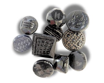 10 Czech black glass buttons from Europe. Perfect embellishments for thrifted or inherited garments—perfect for upcycling. With a shank back