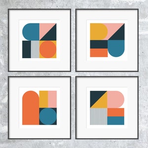 May include: Four framed prints with abstract geometric designs in various colors, including pink, orange, yellow, blue, and black. Each print features a different arrangement of shapes.