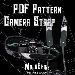 May include: A black Canon camera with a leather camera strap. The strap has a cowhide pattern with white and black markings. The text "PDF PATTERN CAMERA STRAP" is at the top, and "MOONSHINE BESPOKE WORKS" is at the bottom.