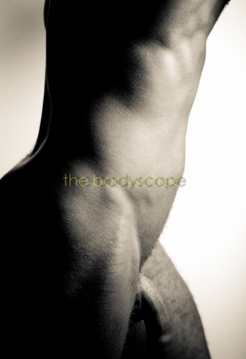 May include: A close-up of a person's torso, showing the side of their body and the outline of their hip.