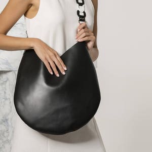 Black leather boho bag for women with handwoven shoulder strap in black with white