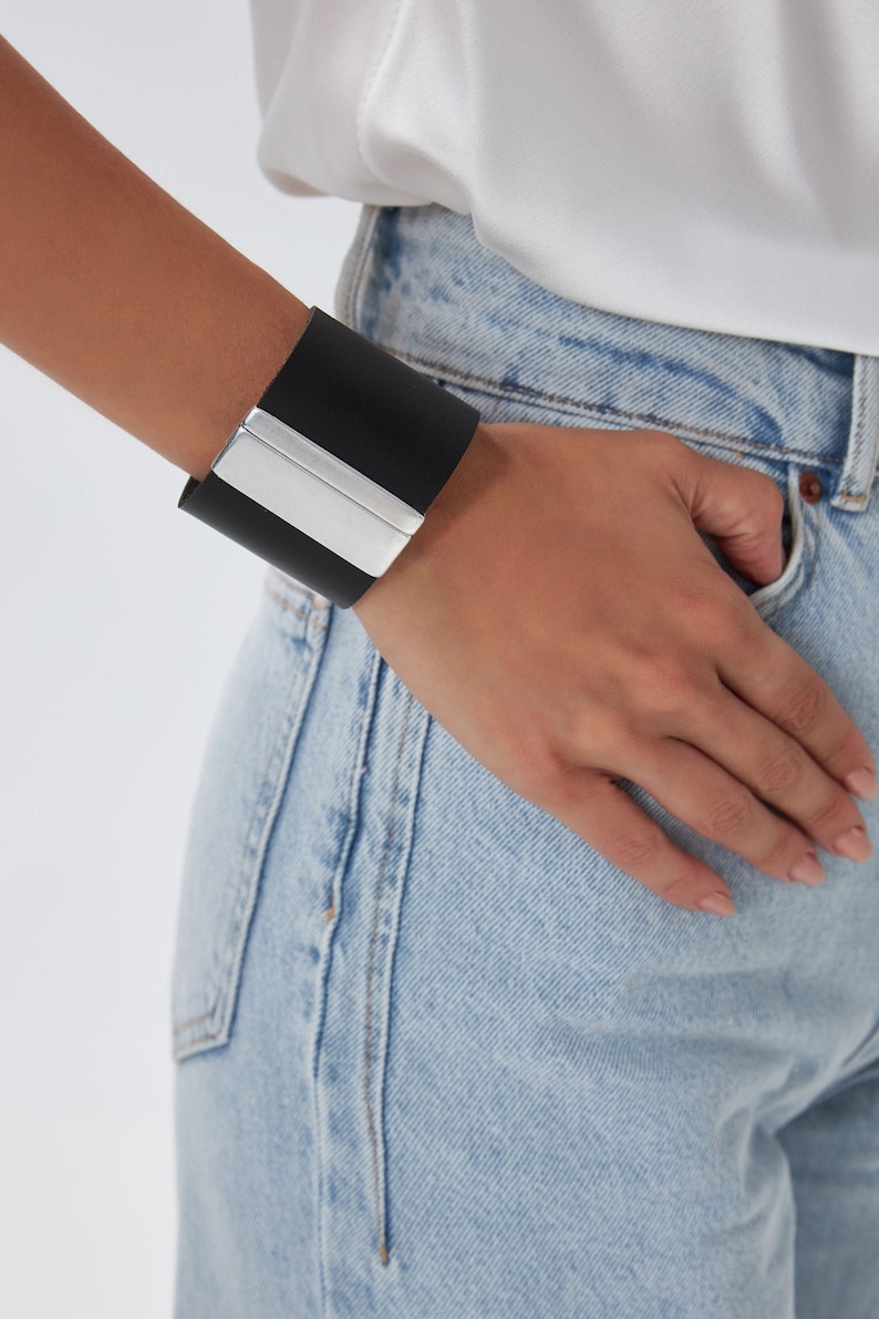 Our Nikol black bracelet is handmade of top quality leather and fastens with a plain magnetic clasp that comes silver plated. This statement piece can be worn with almost anything for a sophisticated style.