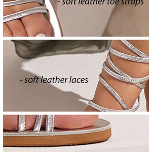 May include: Silver leather sandals with a wraparound ankle strap and a lightweight EVA outsole. The sandals have a leather insole and soft leather laces.