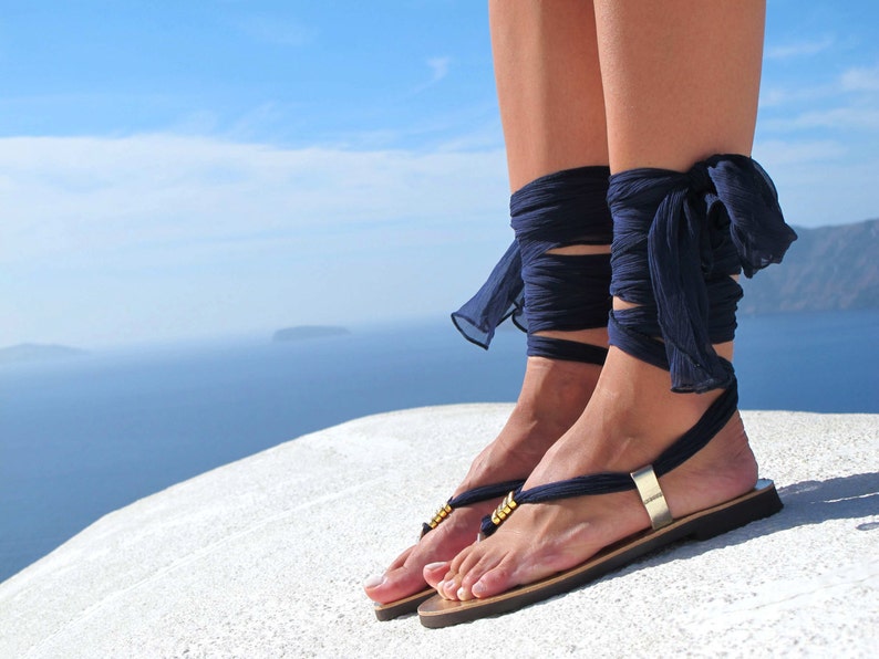 Handmade ribbon wrap sandals featuring Greek Chic Handmades signature interchangeable silk scarf laces and Greek meander embossed metal embellishments. Theese leather women boho flat sandals rest on a super light and comfortable rubber outsole