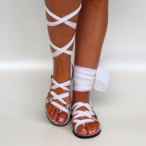 Greek leather sandals, fully customizable, with soft and extra long straps crafted from silk fabric. The lace up flats are handcrafted from top quality leather and set on a super light and comfortable rubbr outsole.