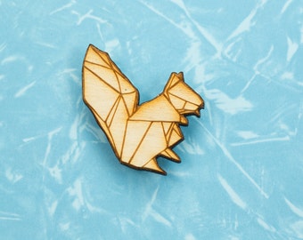 May include: A wooden geometric squirrel cutout, with a light brown colour, on a blue background.