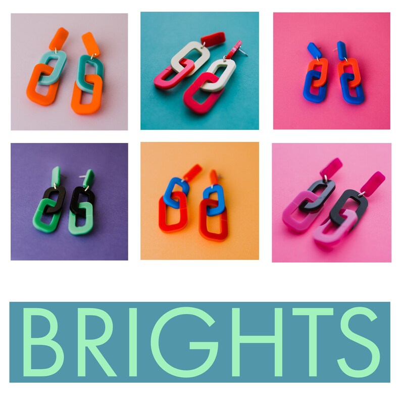 May include: Six pairs of colorful acrylic earrings in the shape of linked chains. Each pair is displayed on a different colored background.