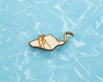 May include: A wooden origami crane cutout in a light brown colour against a blue background.