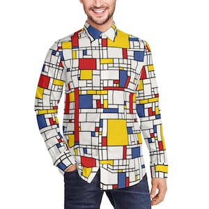 Può includere: Una camicia bianca a maniche lunghe con bottoni e un motivo geometrico in rosso, giallo e blu.