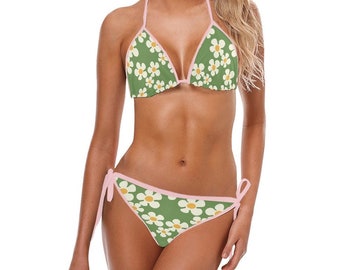 Könnte beinhalten: Ein grüner und weißer Bikini mit Blumenmuster und rosa Besatz. Das Bikinioberteil ist im Dreieckstil gehalten, das Unterteil im Binde-Stil.