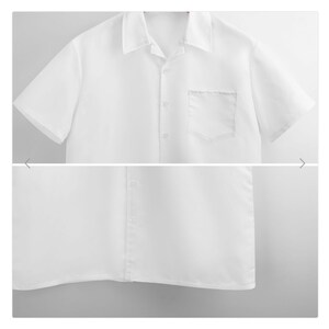 Puede incluir: Una camisa blanca de manga corta con botones y un bolsillo en el pecho.