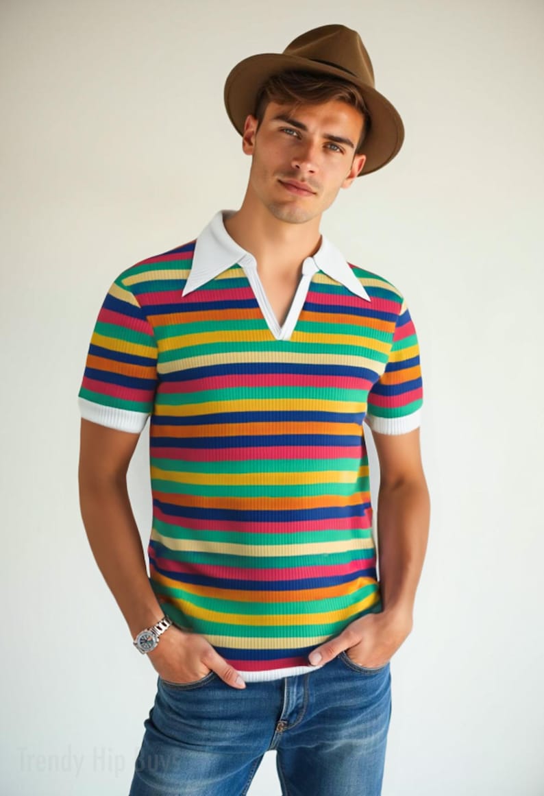 May include: A short-sleeved, striped polo shirt with a white collar and cuffs. The shirt features horizontal stripes in various colors, including red, yellow, green, and blue. The person is wearing a brown fedora hat and blue jeans.