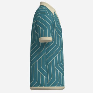 May include: Teal polo shirt with a cream-colored collar and cuffs. The shirt features a white, geometric, linear pattern. The shirt is made of a textured fabric and has a classic polo design.