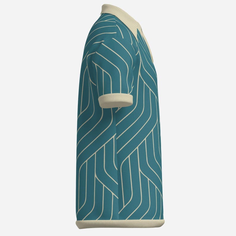 May include: Teal polo shirt with a cream-colored collar and cuffs. The shirt features a white, geometric, linear pattern. The shirt is made of a textured fabric and has a classic polo design.
