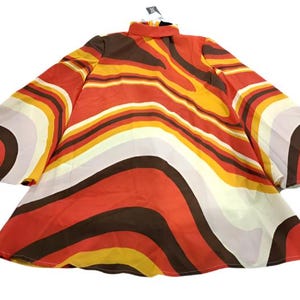 May include: A red, orange, yellow, brown, and white patterned dress with long sleeves and a high neck.