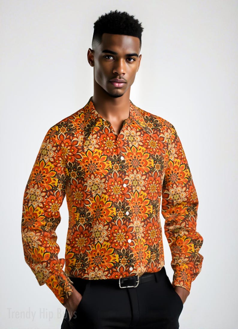 May include: A long-sleeved button-down shirt with a colorful, geometric pattern in shades of orange, yellow, and brown. The shirt has a collared neckline and a button closure.