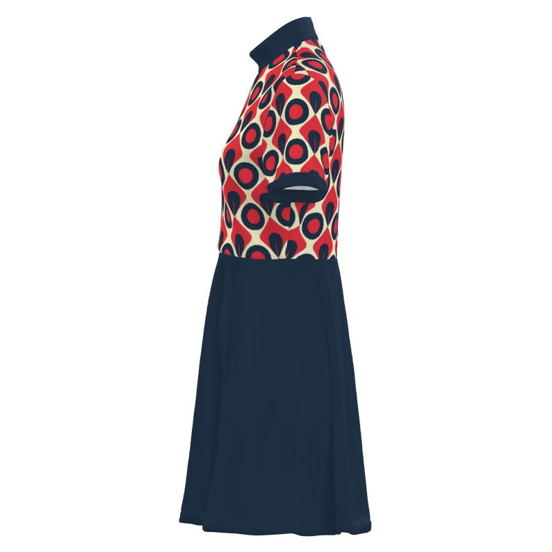May include: A navy blue dress with a high collar and short sleeves. The top portion features a red, cream, and navy blue geometric pattern. The skirt is a solid navy blue, creating a color-blocked design. The dress has a retro, mod style.