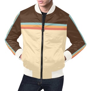 May include: A satin bomber jacket with a cream-colored body, brown upper section, and white cuffs and collar. The jacket features a horizontal stripe design in orange, blue, and yellow. The sleeves have a matching stripe design.