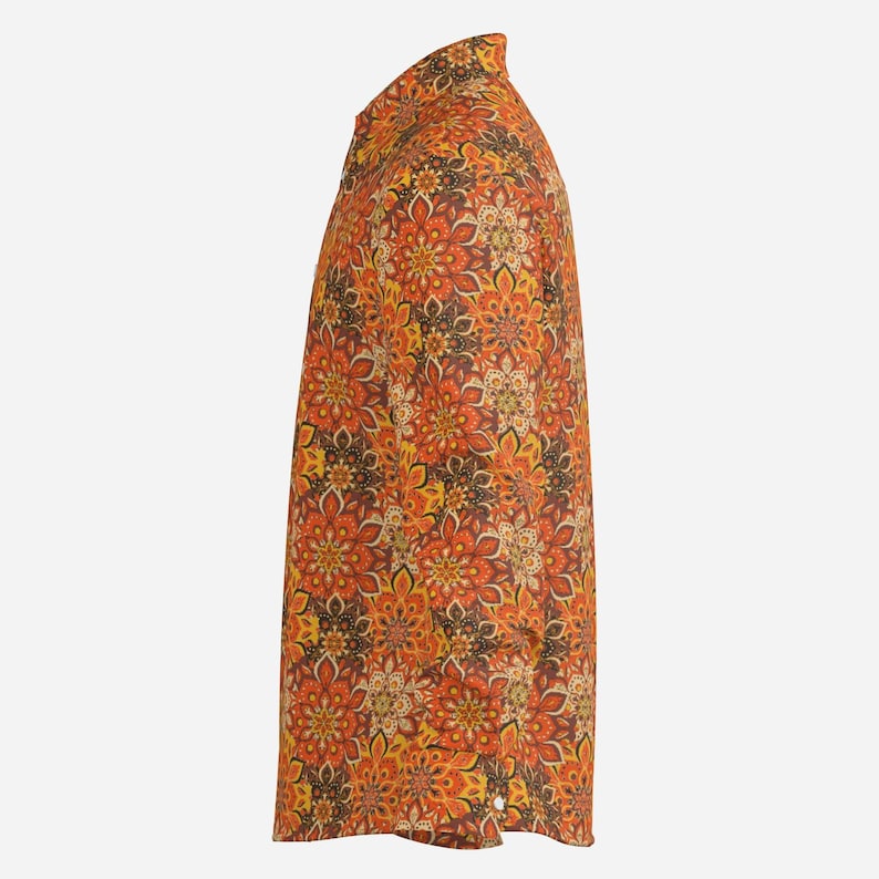 May include: A long-sleeved shirt with a colorful floral pattern in shades of orange, yellow, and brown. The shirt has a button-up collar and a relaxed fit.