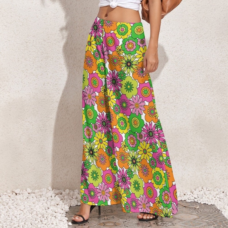 May include: Wide-leg trousers with a floral print featuring pink, yellow and green flowers on a white background.