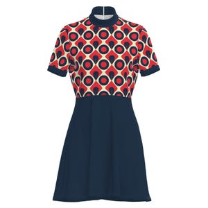 May include: A short-sleeved dress featuring a retro geometric pattern in red, navy, and cream. The bodice has a high neckline and a repeating pattern of circles and diamonds. The skirt is a solid navy blue, creating a contrast with the patterned top.