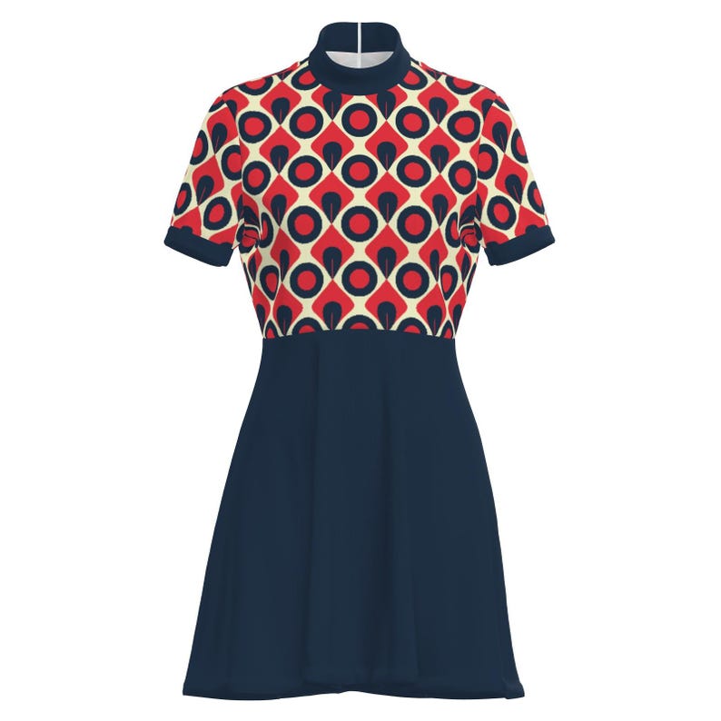 May include: A short-sleeved dress featuring a retro geometric pattern in red, navy, and cream. The bodice has a high neckline and a repeating pattern of circles and diamonds. The skirt is a solid navy blue, creating a contrast with the patterned top.